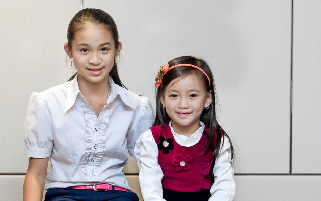 Teen girl with sister after cleft surgery