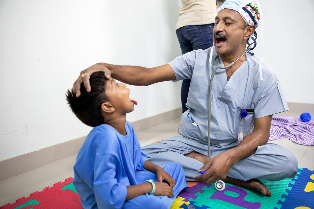 Volunteer Anaesthesiologist, Raju Ghose, with nine-years-old Bipul. Photo: Jasmin Shah