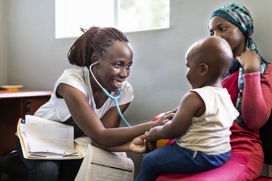 Anaesthetist Wambui with a child in Malawi