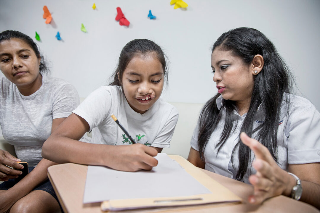 Volunteer Psychologist Dr. Maria José Chevéz, right, consults with Iris and her mother, Sandra, at the Operation Smile Nicaragua care centre in Managua. Photo: Jörgen Hildebrandt