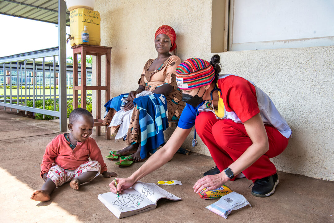 Volunteer Nurse, Linda James plays with patient Aime. Photo: Margherita Mirabella