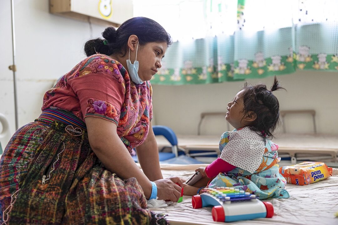 Heidy waits patiently with her 21-month-old daughter, Leyda, for the moment when volunteers will call her into the operating room. This is the sixth time Heidy has brought Leyda to a surgical program with the hope that she would be receive a new smile. Photo: Lorenzo Monacelli.