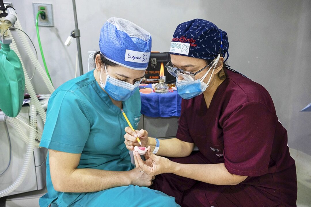 Guatemalans volunteers dentist Dr. Monica De Leon, right, and Dr. Eugenia Azmitia, left me about the specifics of creating obturators for patients with cleft palate. Photo: Lorenzo Monacelli.