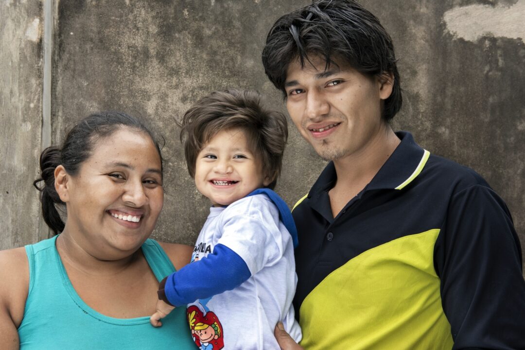 Nora, Damian and his dad, Alexander, share their smiles seven months after Damian received his cleft lip surgery. Photo: Margherita Mirabella.