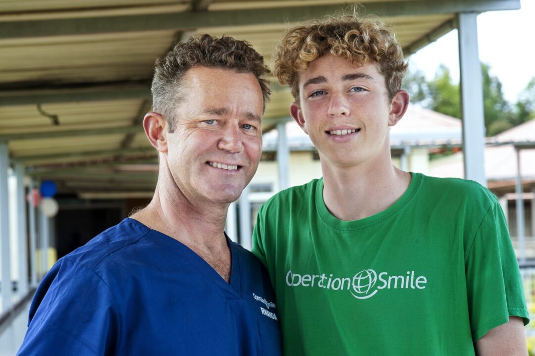 Dr. Billy Magee, left, stands beside his 14-year-old son, Liam, during a 2022 surgical programme in Bushenge, Rwanda. Photo: Margherita Mirabella.