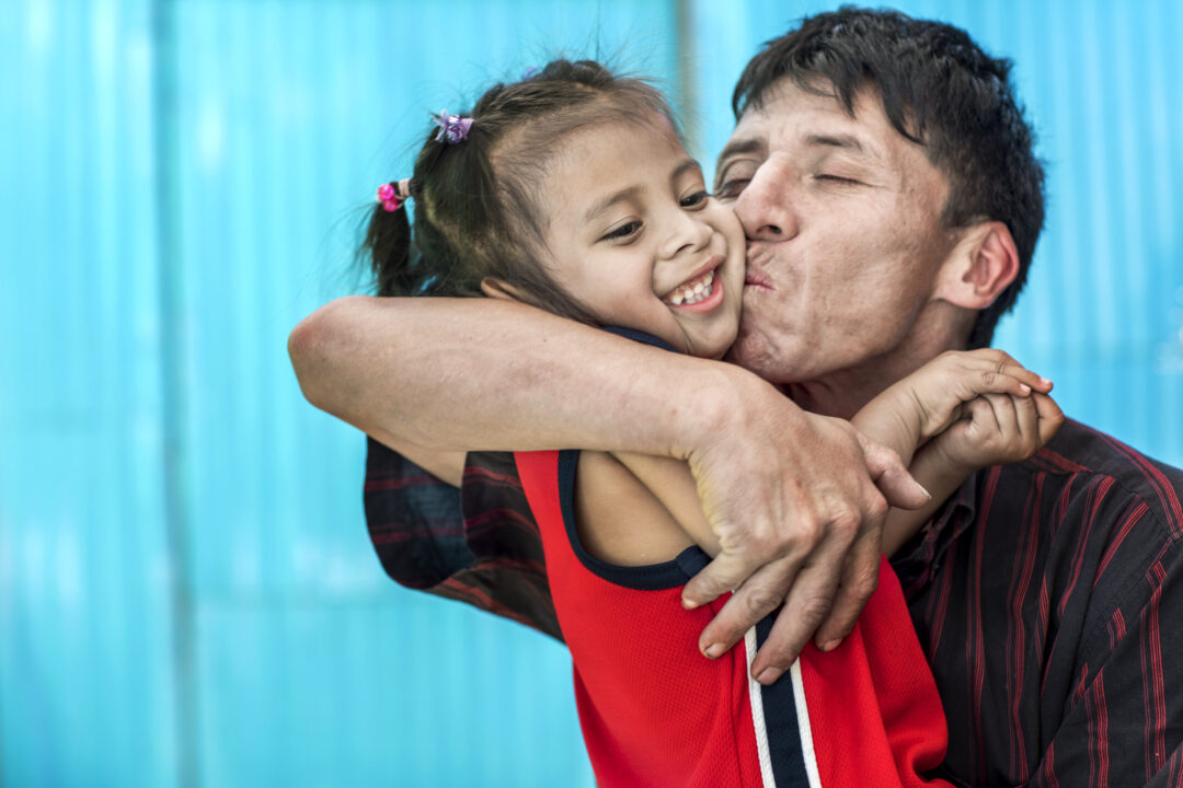 Karla, 3 years old, gets a big kiss from her dad, Angel, 15 months after she received cleft surgery from Operation Smile Mexico. 