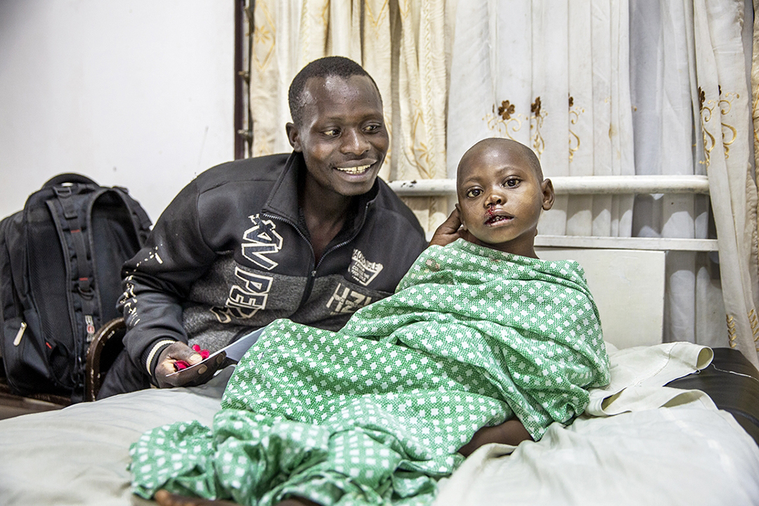 Jean smiles and looks at daughter Valentine as she lays in a hospital bed. Photo by Jorgen Hildebrandt.