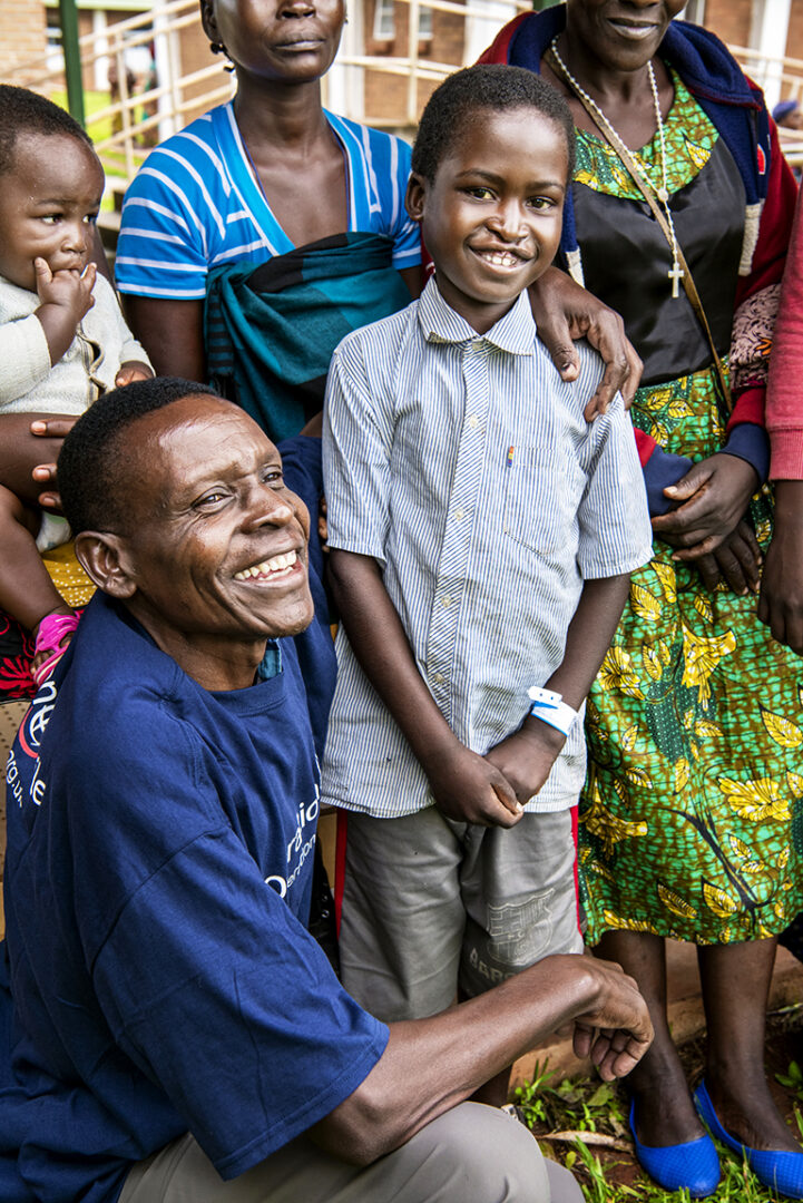 Community volunteer Alick and Isaac, before his life-changing surgery. Photo: Margherita Mirabella