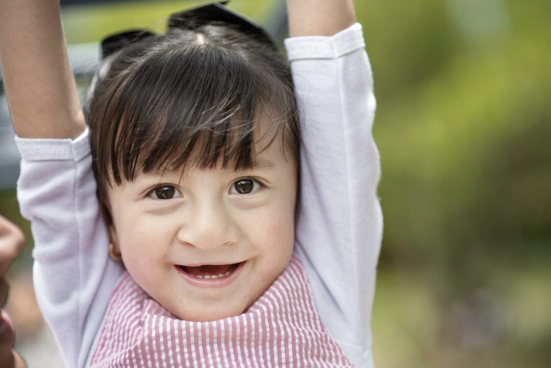 Luciana plays in a playground after her cleft lip surgery. 
