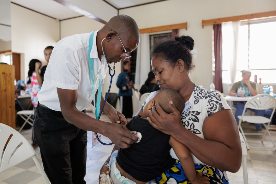 Little Matthias and his mother during a medical evaluation provided by Dr Raul Atibo, paediatrician from Mozambique. Photo: Lorenzo Monacelli
