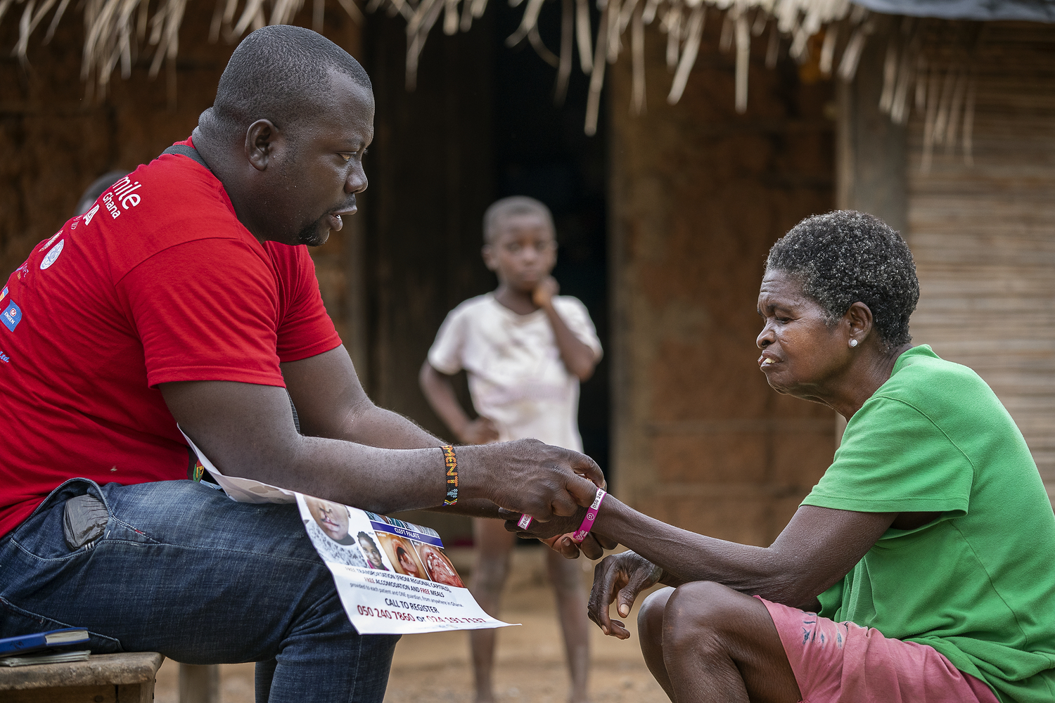 Patient Coordinator Clement Ofosuhemeng engaging with a patient during an awareness campaign.