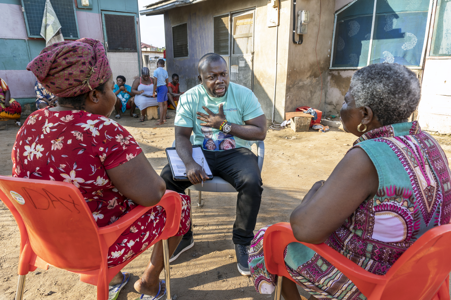 Patient Coordinator Clement Ofosuhemeng interacting with parents during a surgical programme. 